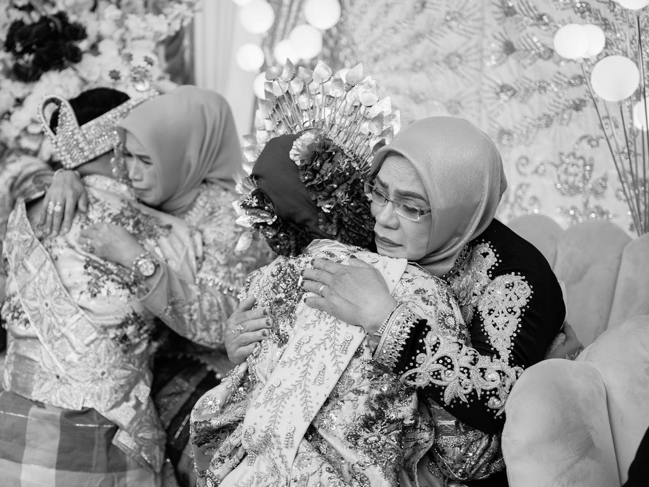 Heartfelt embrace between family members at a traditional wedding in Kendari.